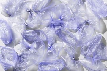Plastic Bag Free Day background. Violet monochrome plastic bags top view pattern, texture...
