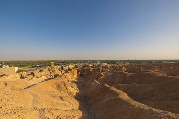 Fototapeta na wymiar Sunset views across over the oasis town of Al Hasa from Al Qarah hills, Saudi Arabia