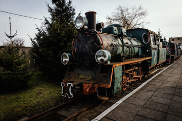 Fototapeta premium Vintage locomotive, steam train in an outdoor depot.