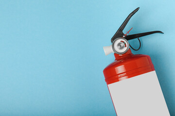 Fire extinguisher on a blue background . Fire protection, home fire extinguisher. home security...