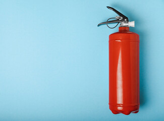 Fire extinguisher on a blue background . Fire protection, home fire extinguisher. home security...