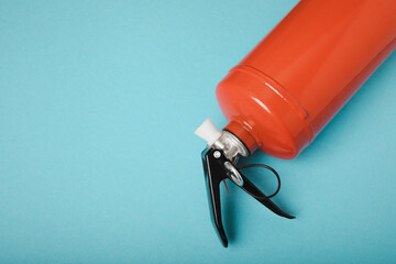 Fire extinguisher on a blue background . Fire protection, home fire extinguisher. home security concept. Place for text. Copy space.banner
