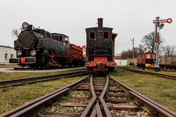Obraz premium Retro locomotive, steam train parked in an outdoor depot.