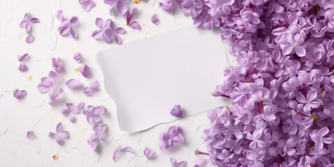 Blank white card in the center, surrounded by lilac petals, white background top view, AI Generated