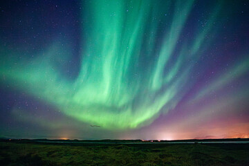 A green sky of shimmering and dancing Northern Lights, aurora, in Iceland
