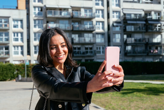 Happy ethnic woman taking a selfie