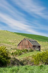 Red barn under a blue sky in eastern Washington.