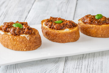 Ciabatta bruschettas with mozzarella and puttanesca