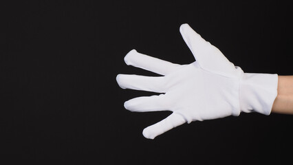 Fototapeta na wymiar Hand wear fabric gloves or cotton glove on black background.