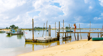 Arcachon basin in France- fishing boat and wooden pier, atlantic ocean, harbor- tourism in Landes - obrazy, fototapety, plakaty