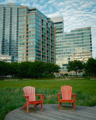 Adirondack chairs and modern buildings, in Long Island City, Queens, New York