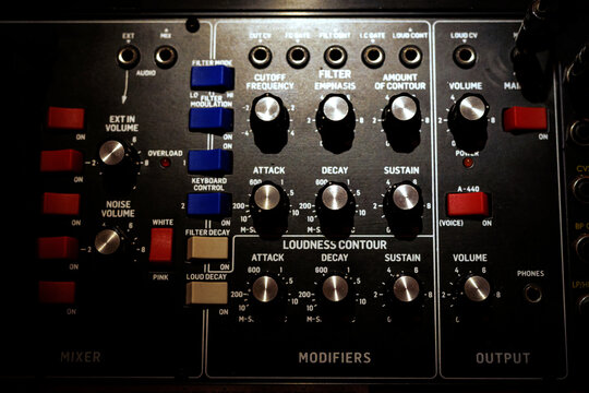 Old school audio mixer with metal sliders and knobs