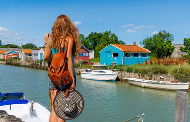 Woman travel in Ile d'Oleron, Chateau d'Oleron- tour tourism in France - obrazy, fototapety, plakaty