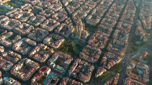 Aerial view of Barcelona Eixample residential district and La Sagrada Familia Basilica at sunrise. Catalonia, Spain