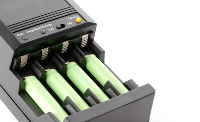 AAA batteries rechargeable in accumulator charger, isolated on a white background