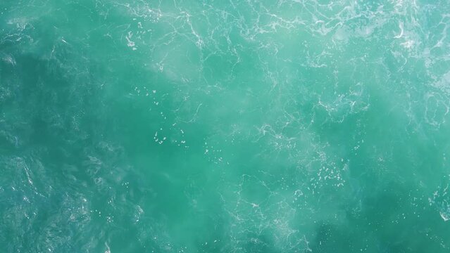 Turquoise ocean water waving agitated aerial view. Deep sea surface rippling