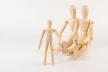 Family of wooden puppets with the kid on white background.
