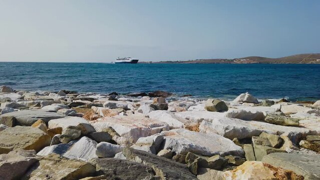 Parikia, Paros Island, Greece - 28 September 2020: View of the bay of Paros. Passenger ferry departing bay at Paros.