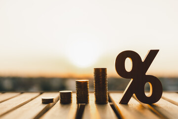Percentage model with coins stack. Concepts of the banking system, rising interest rates, inflation, deflation, and savings. - obrazy, fototapety, plakaty