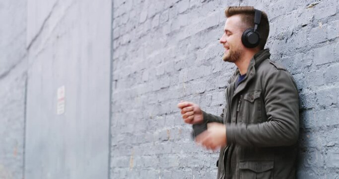 Man, streaming and listening to music on headphones or quality cellphone sound, audio or drummer dancing to song. Person, listen or dance to happy track, stream or radio on bluetooth technology