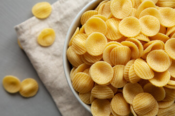 Dry, Uncooked Orecchiette Pasta in a Bowl, top view. Overhead, from above, flat lay.