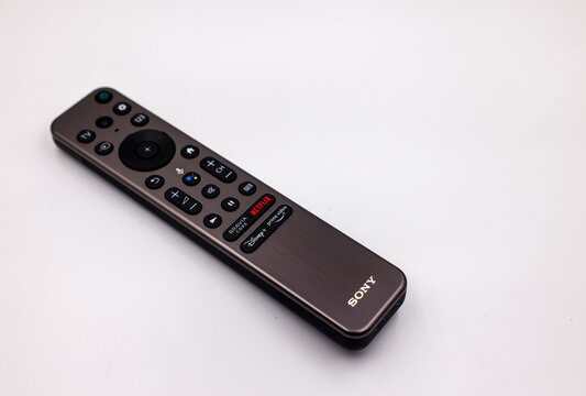 Sony remote control device for TV television isolated on white background. Keypad has direct buttons for Netflix, Bravia core, "Disney+" and "Amazon Prime video" streaming apps or channels