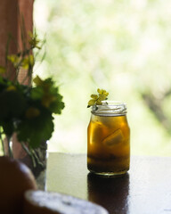 Bumble coffee icy espresso with orange juice in glass bottle, selective focus