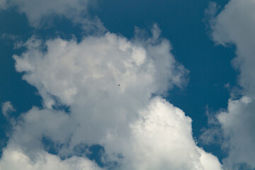 Fototapeta premium Blue sky with white clouds. Blue sky with white clouds close-up. White clouds on a sunny day
