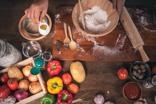 Top view images, a people preparing equipment and ingredients, flour, vegetables for making pizza. to food and pizza homemade conept.