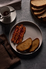 Delicious Breakfast: Crispy Bacon, Toasted Sliced Bread, and Coffee