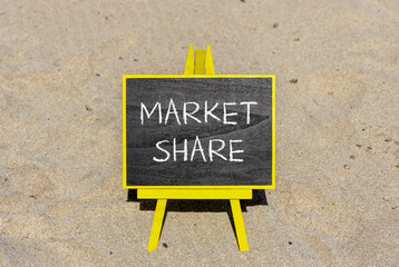 Market share symbol. Concept words Market share on beautiful black chalk blackboard on a beautiful sand beach background. Business and Market share concept. Copy space.