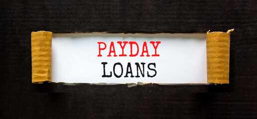 Payday loans symbol. Concept words Payday loans on beautiful white paper. Beautiful black paper cardboard background. Business and Payday loans concept. Copy space.