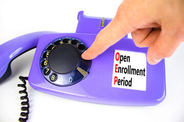 OEP symbol. Concept words OEP Open enrollment period on beautiful old disk phone. Doctor hand....