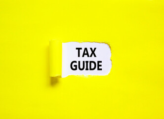 Tax guide symbol. Concept words Tax guide on beautiful white paper. Beautiful yellow table yellow background. Business and Tax guide concept. Copy space.