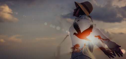 Double exposure. woman and free bird enjoying nature on sunset background, release, freedom,...
