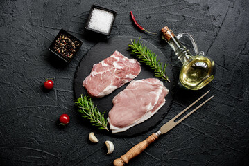 raw veal steaks on stone background