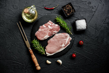 raw veal steaks on stone background