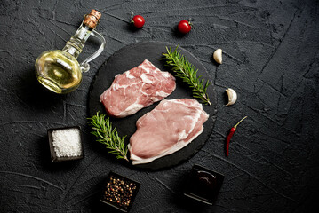 raw veal steaks on stone background