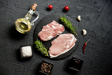 raw veal steaks on stone background