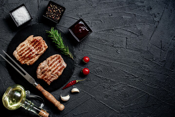 grilled veal steaks on stone background with copy space for your text