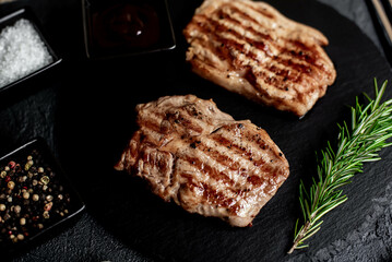 grilled veal steaks on stone background
