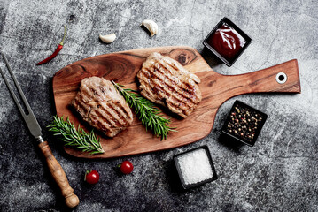 grilled veal steaks on stone background