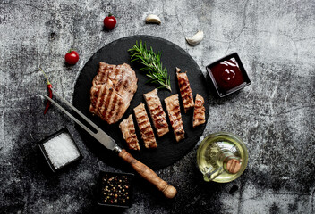 grilled veal steaks on stone background