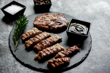 grilled veal steaks on stone background