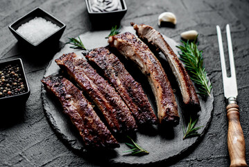 pork ribs on a grill on a stone background 