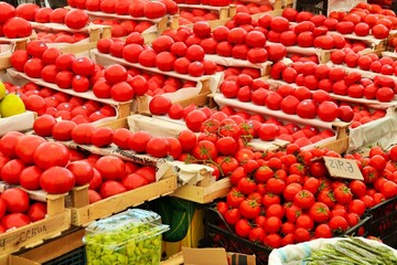 Fresh bright tomatoes in boxes at the vegetable market