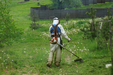 man in uniform mows the lawn