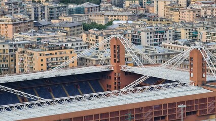 Genoa, Italy - May 6, 2023: Top view of the city of Genoa at sunset from the mountains. Aerial view of Genoa and Sampdoria soccer teams stadium in Genoa Marassi in Italy.