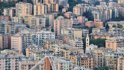 Genoa, Italy - May 6, 2023: Top view of the city of Genoa at sunset from the mountains. Aerial view of Genoa and Sampdoria soccer teams stadium in Genoa Marassi in Italy.