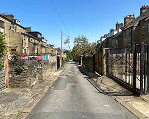 Back lane, running between large Victorian stone houses near, St Marys Road, Manningham, Bradford, UK